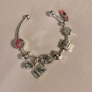 Brand new silver charm bracelet, beach and travel-themed charms included.